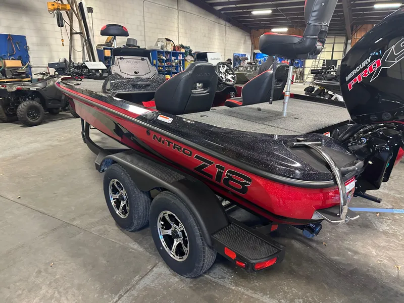 Slide: The Image of 2025 Nitro Z18 Pro boat in a warehouse, featuring a sleek red and black design. - 6