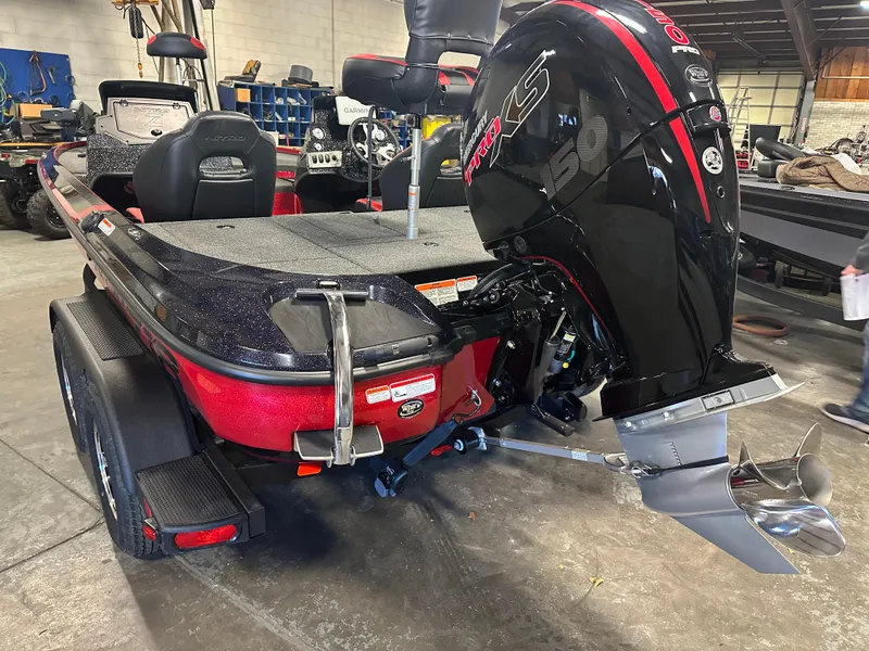 Slide: The Image of Red Nitro Z18 Pro 2025 boat with powerful outboard motor in a garage setting. - 7