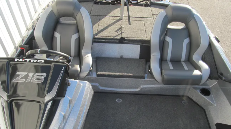 Slide: The Image of 2025 Nitro Z18 Pro boat interior with dual gray seats and steering console. - 13