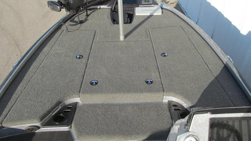Slide: The Image of 2025 Nitro Z18 Pro boat deck with carpeted surface and storage compartments. - 8