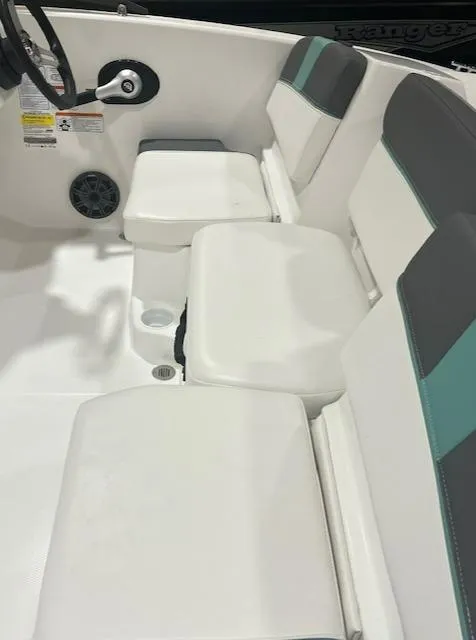 Slide: The Image of 2025 Tahoe T16 boat interior with white and gray seating, teal accents, and steering wheel. - 2