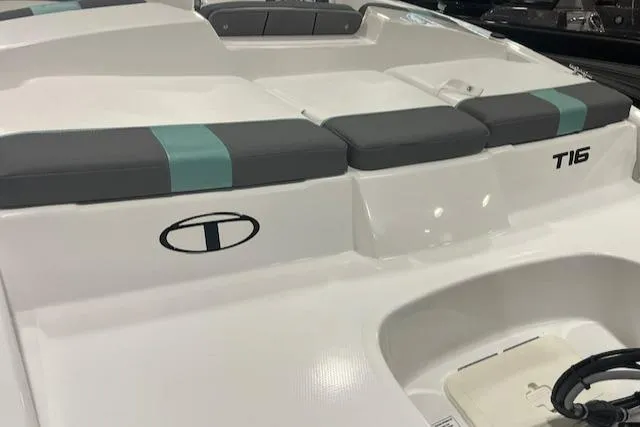 Slide: The Image of 2025 Tahoe T16 boat interior with cushioned seating and logo. - 5