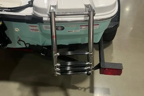 Slide: The Image of 2025 Tahoe T16 boat with foldable rear ladder and trailer attachment. - 9