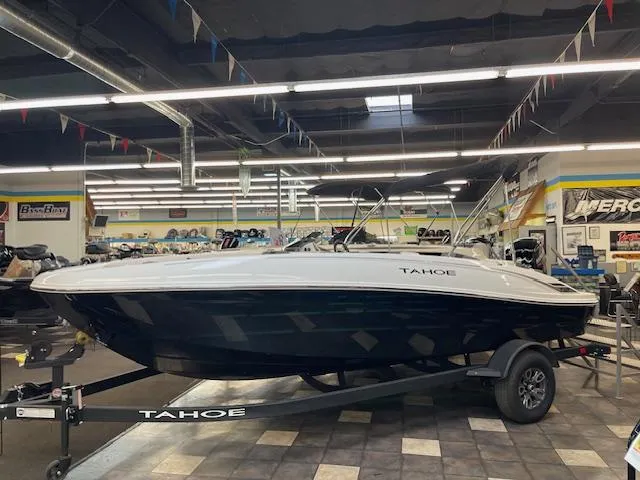 The Image of 2025 Tahoe T18 boat displayed in showroom with canopy and trailer. - 0