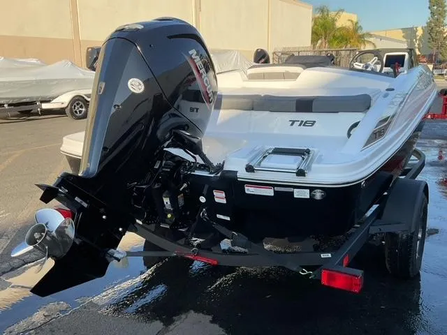 Slide: The Image of 2025 Tahoe T18 boat with Mercury outboard motor in a parking lot. - 10