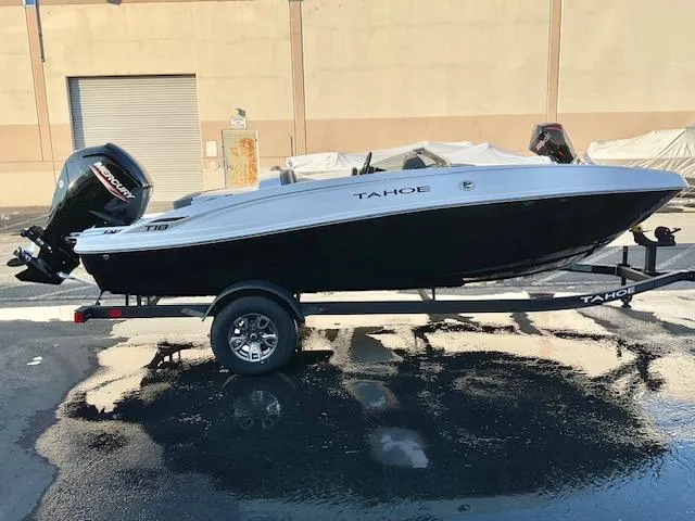 Slide: The Image of 2025 Tahoe T18 boat displayed in a showroom with modern seating and sleek design. - 3