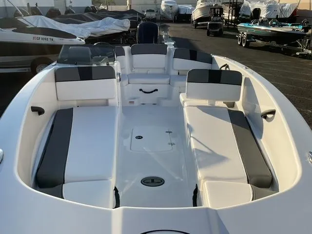 Slide: The Image of 2025 Tahoe T18 boat on trailer, black and white design, parked outdoors. - 5