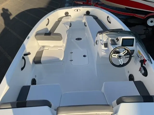 Slide: The Image of 2025 Tahoe T18 boat on trailer in a marina setting. - 6