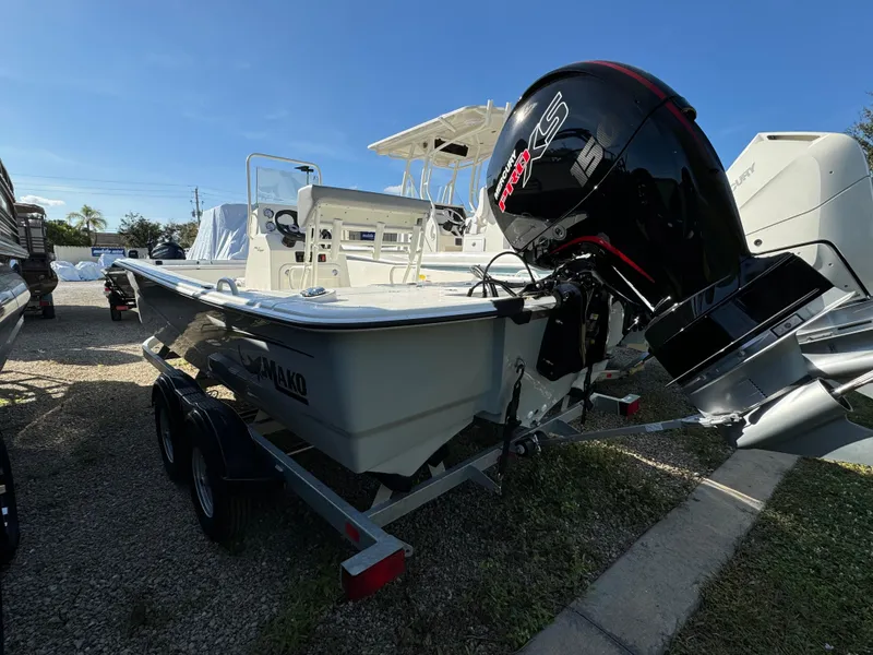 Slide: The Image of 2025 Mako Pro Skiff 19 CC boat on trailer with powerful outboard motor. - 2