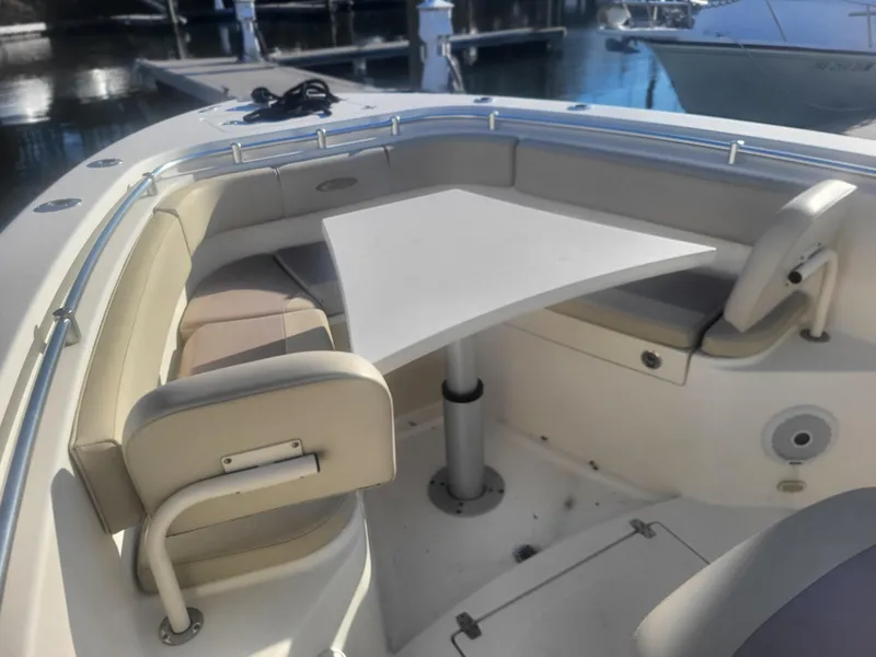 Slide: The Image of 2016 Cobia 277 Center Console boat with seating and table in the bow area. - 11
