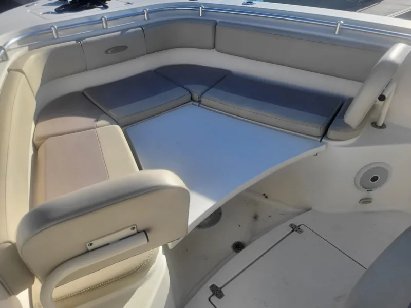 Slide: The Image of 2016 Cobia 277 Center Console boat with cushioned seating area. - 12