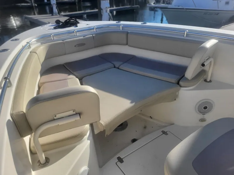 Slide: The Image of 2016 Cobia 277 Center Console boat with cushioned seating area. - 13
