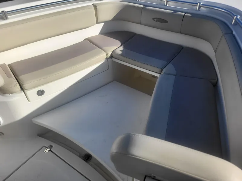 Slide: The Image of 2016 Cobia 277 Center Console boat seating area with cushioned benches. - 14