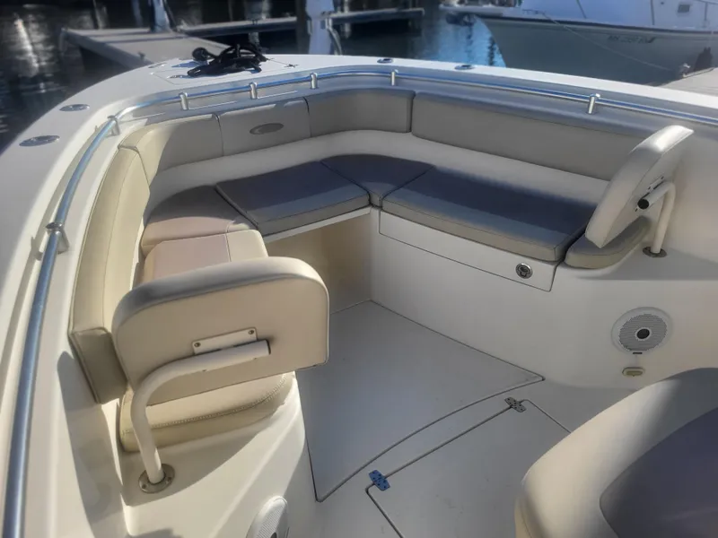Slide: The Image of 2016 Cobia 277 Center Console boat interior with cushioned seating and storage. - 15
