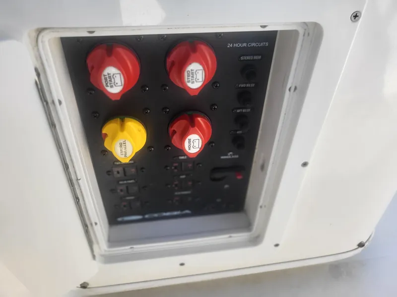 Slide: The Image of Control panel of a 2016 Cobia 277 Center Console boat with switches and circuits. - 16