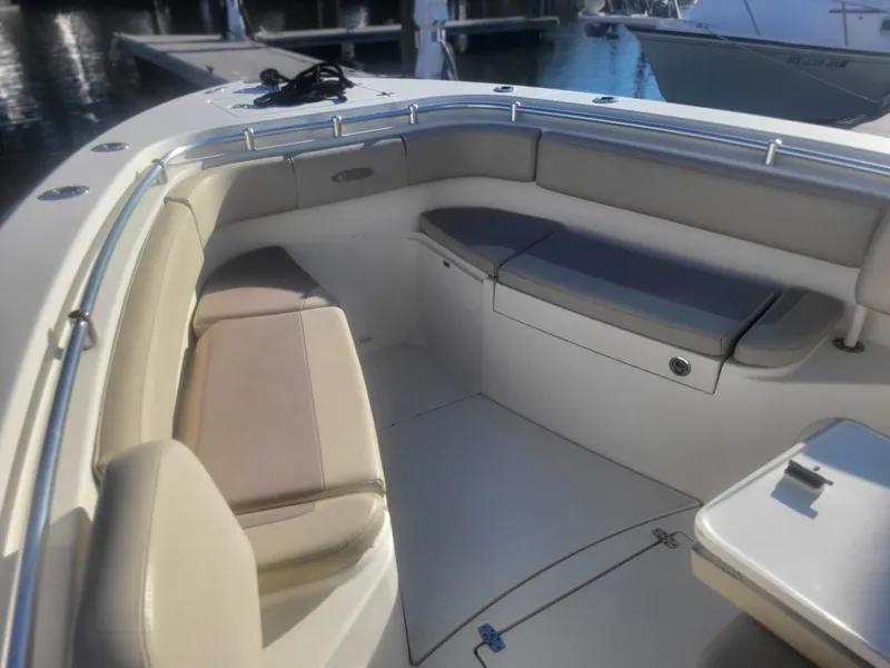 Slide: The Image of 2016 Cobia 277 Center Console boat interior with cushioned seating and storage. - 18
