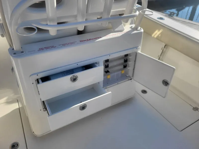 Slide: The Image of 2016 Cobia 277 Center Console storage compartments with open drawers and cabinet. - 24