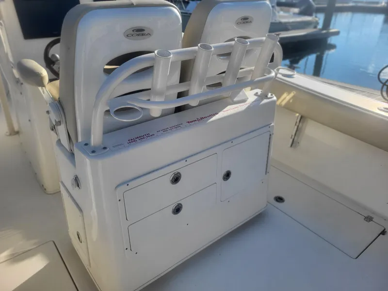 Slide: The Image of 2016 Cobia 277 Center Console boat interior with rod holders and storage compartments. - 25