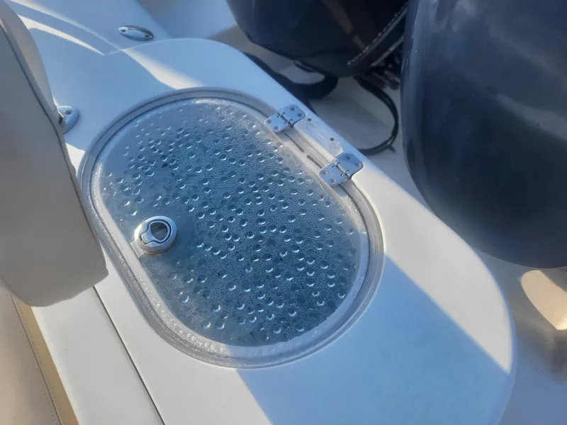 Slide: The Image of Cobia 277 Center Console 2016 boat detail with water droplets on hatch cover. - 26