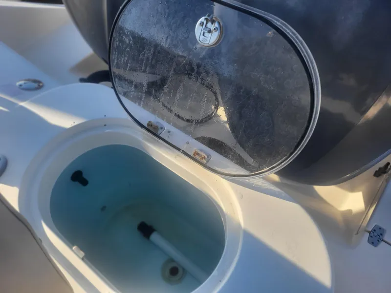 Slide: The Image of Cobia 277 Center Console 2016 livewell with open lid, showing interior details. - 27