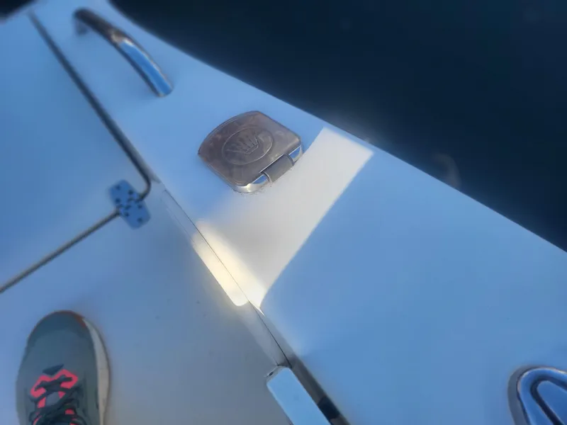 Slide: The Image of 2016 Cobia 277 Center Console boat deck with cleat and sneaker. - 28