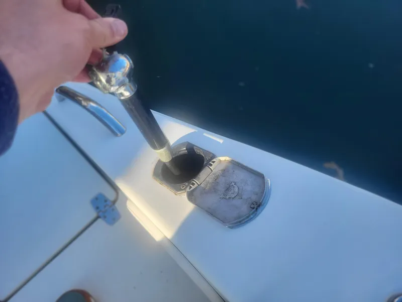 Slide: The Image of Filling fuel on a 2016 Cobia 277 Center Console boat. - 29