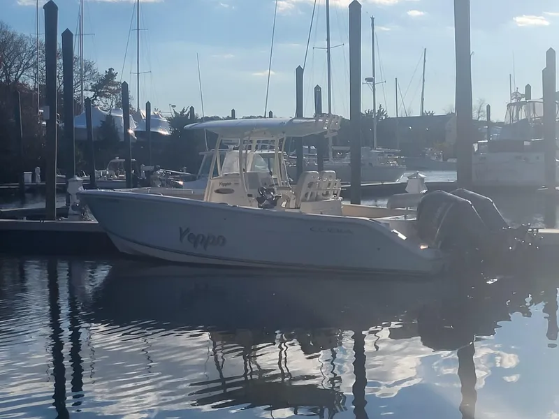 Slide: The Image of 2016 Cobia 277 Center Console boat docked in a marina. - 3
