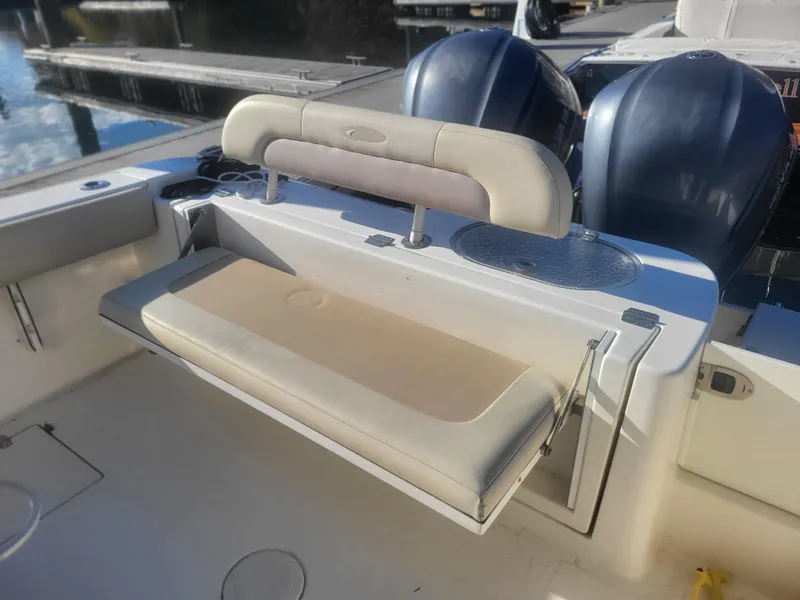 Slide: The Image of 2016 Cobia 277 Center Console boat with cushioned seating and dual engines. - 31