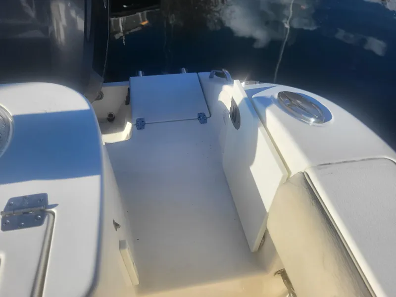 Slide: The Image of 2016 Cobia 277 Center Console boat deck with storage compartments. - 33