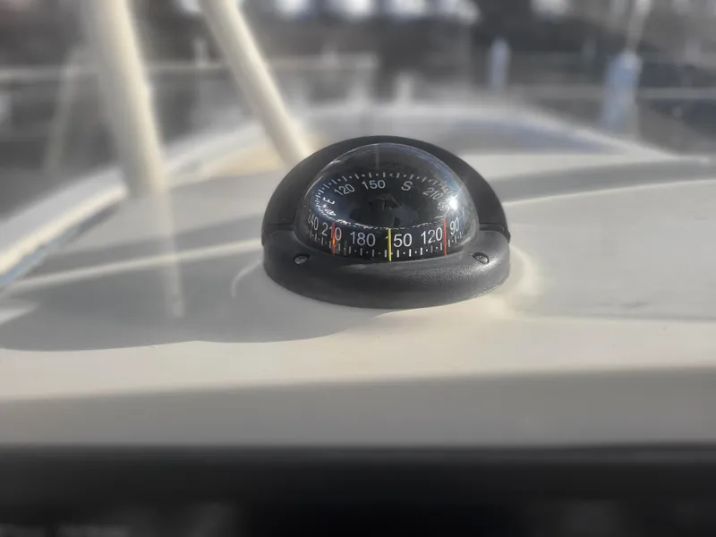 Slide: The Image of Compass on 2016 Cobia 277 Center Console boat dashboard. - 41