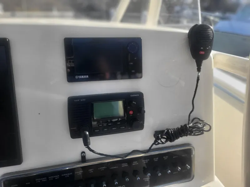 Slide: The Image of 2016 Cobia 277 Center Console dashboard with Yamaha electronics and communication equipment. - 43