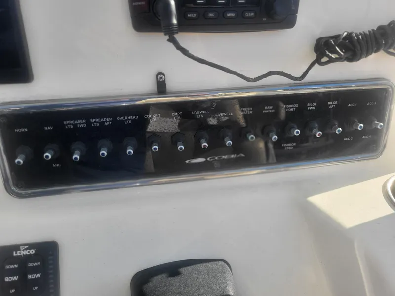 Slide: The Image of Control panel of a 2016 Cobia 277 Center Console boat with labeled switches. - 44