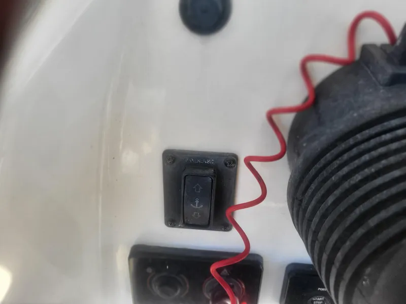 Slide: The Image of Close-up of a 2016 Cobia 277 Center Console boat control panel with anchor switch. - 47