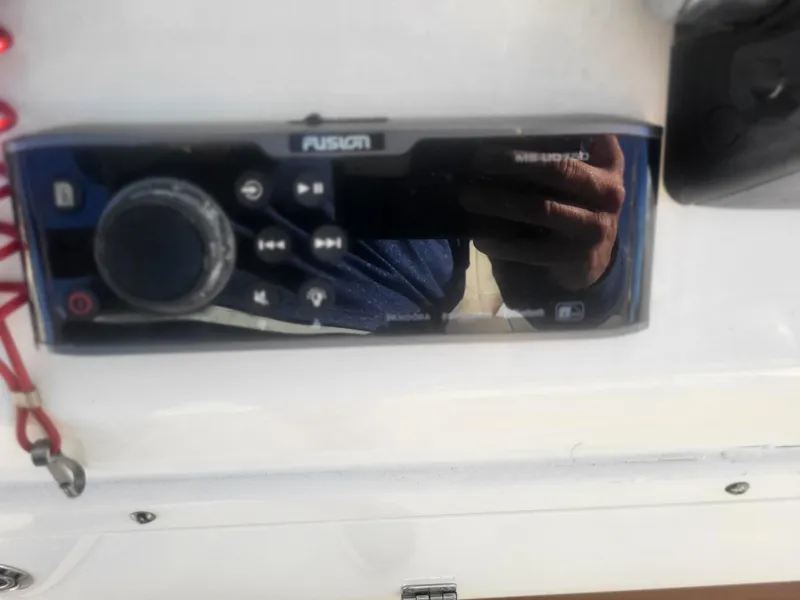 Slide: The Image of Fusion marine stereo on 2016 Cobia 277 Center Console boat dashboard. - 49