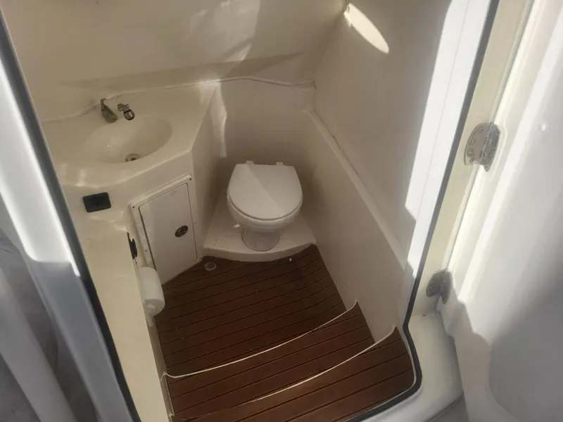 Slide: The Image of 2016 Cobia 277 Center Console boat bathroom with sink and toilet. - 8