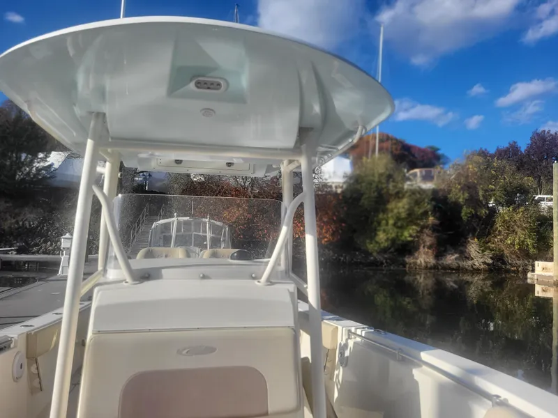Slide: The Image of 2016 Cobia 277 Center Console boat docked on a sunny day. - 9