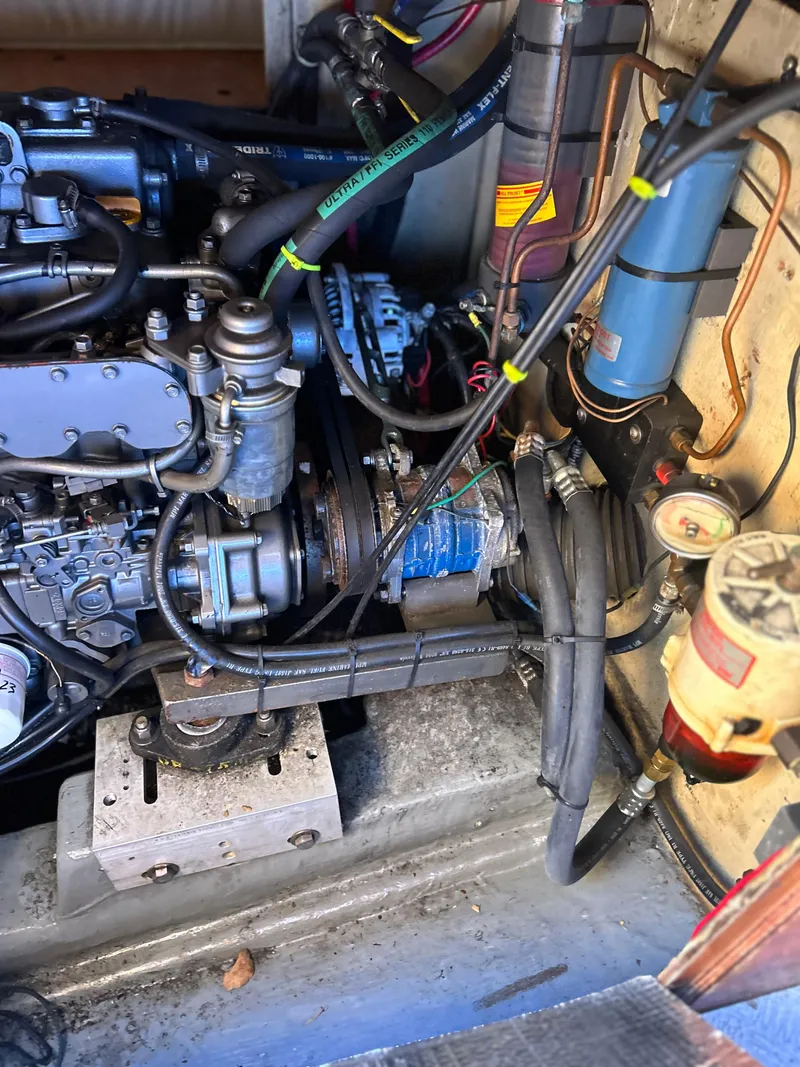 Slide: The Image of Engine compartment of a 1986 Wauquiez Centurion 47 sailboat, showing detailed mechanical components. - 12