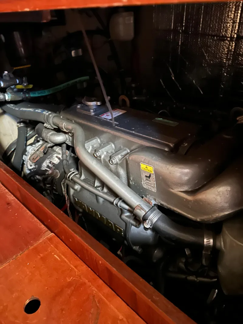 Slide: The Image of Engine compartment of a 1986 Wauquiez Centurion 47 sailboat, showcasing detailed mechanical components. - 15
