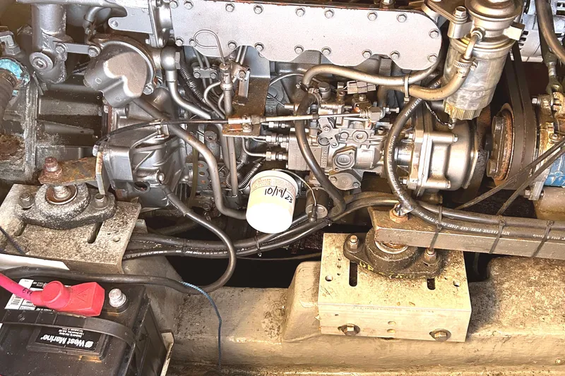 Slide: The Image of Engine compartment of a 1986 Wauquiez Centurion 47 sailboat, showing mechanical components. - 18