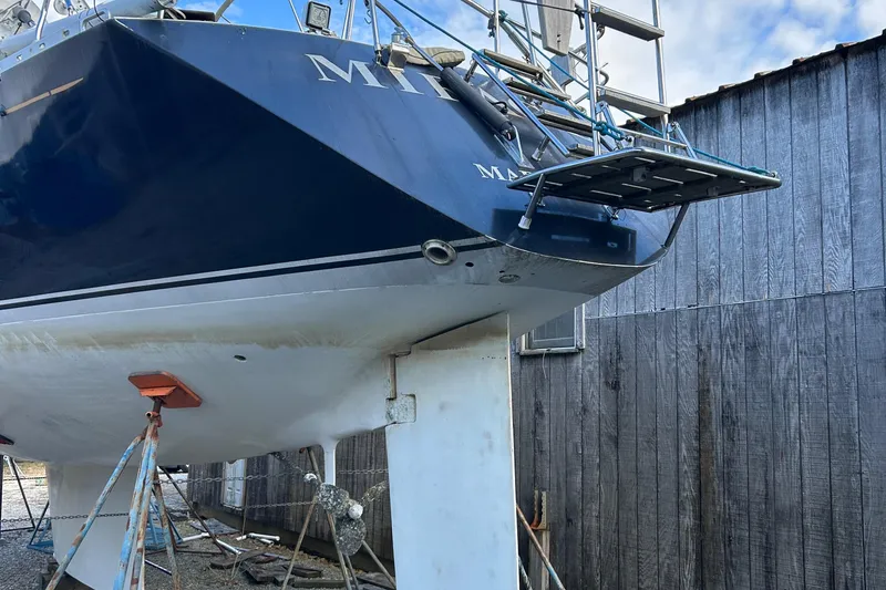 Slide: The Image of Wauquiez Centurion 47 sailboat from 1986 on dry dock, showing hull and rudder. - 20