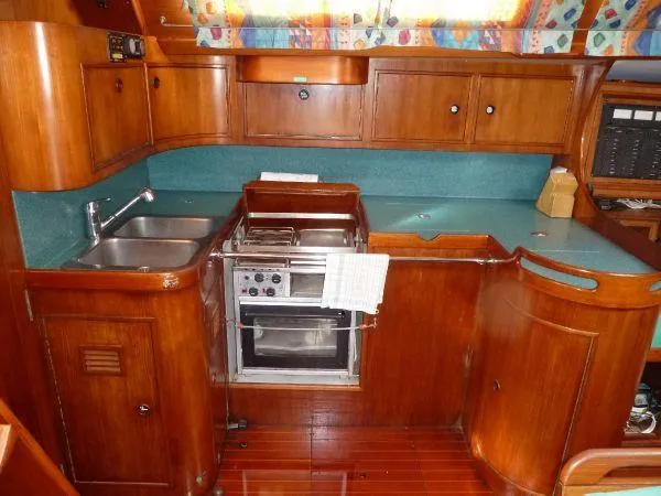 Slide: The Image of Interior of 1986 Wauquiez Centurion 47 yacht kitchen with wood cabinetry and dual sinks. - 6