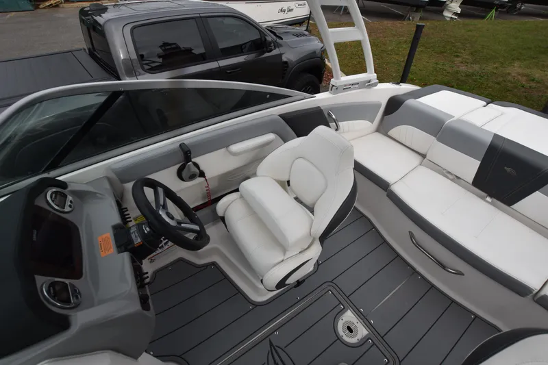 Slide: The Image of 2022 Chaparral 21 SSi OB boat interior with white seating and steering wheel. - 11