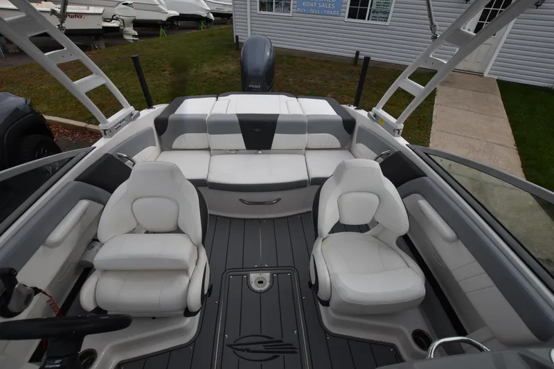 Slide: The Image of 2022 Chaparral 21 SSi OB boat interior with white seating and modern design. - 15