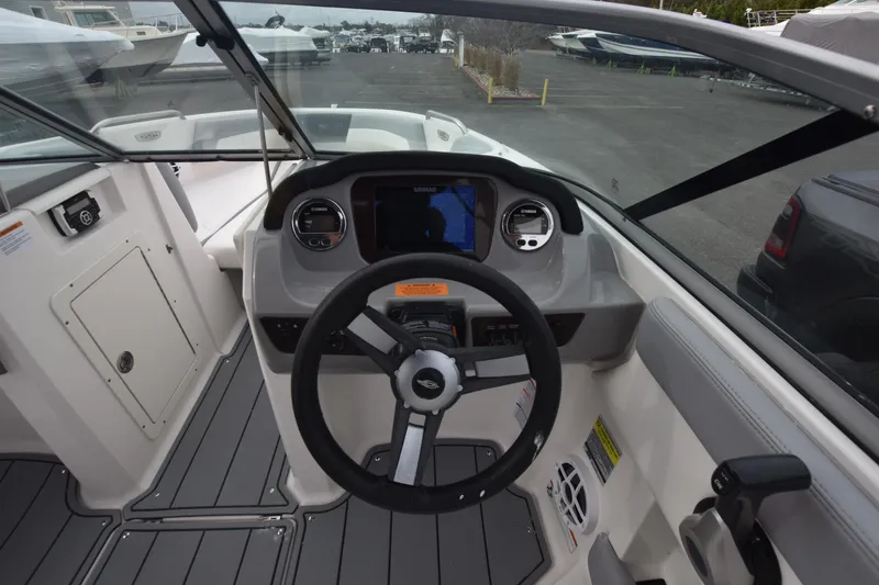 Slide: The Image of 2022 Chaparral 21 SSi OB boat dashboard with steering wheel and navigation display. - 17