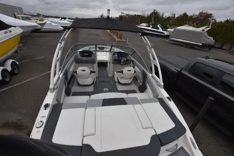 Slide: The Image of 2022 Chaparral 21 SSi OB boat with spacious seating and sleek design. - 7