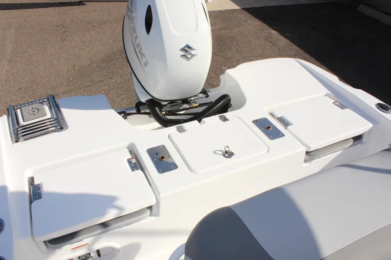 Slide: The Image of 2025 NauticStar 191 Hybrid boat with Suzuki outboard motor, rear deck view. - 14