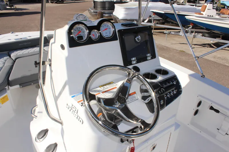Slide: The Image of 2025 NauticStar 191 Hybrid boat dashboard with steering wheel and gauges. - 17