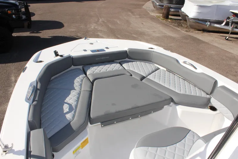 Slide: The Image of 2025 NauticStar 191 Hybrid boat interior with gray cushioned seating. - 19