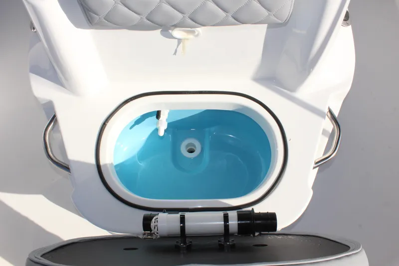 Slide: The Image of 2025 NauticStar 191 Hybrid boat livewell with blue interior and seating. - 22