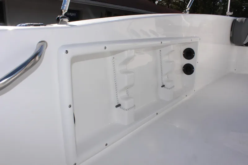 Slide: The Image of 2025 NauticStar 191 Hybrid boat interior detail with storage compartment and cup holders. - 23